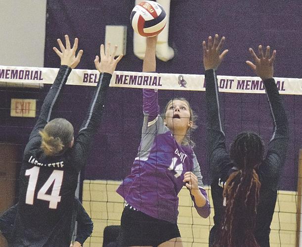  Photo of volleyball team at the net blocking a ball